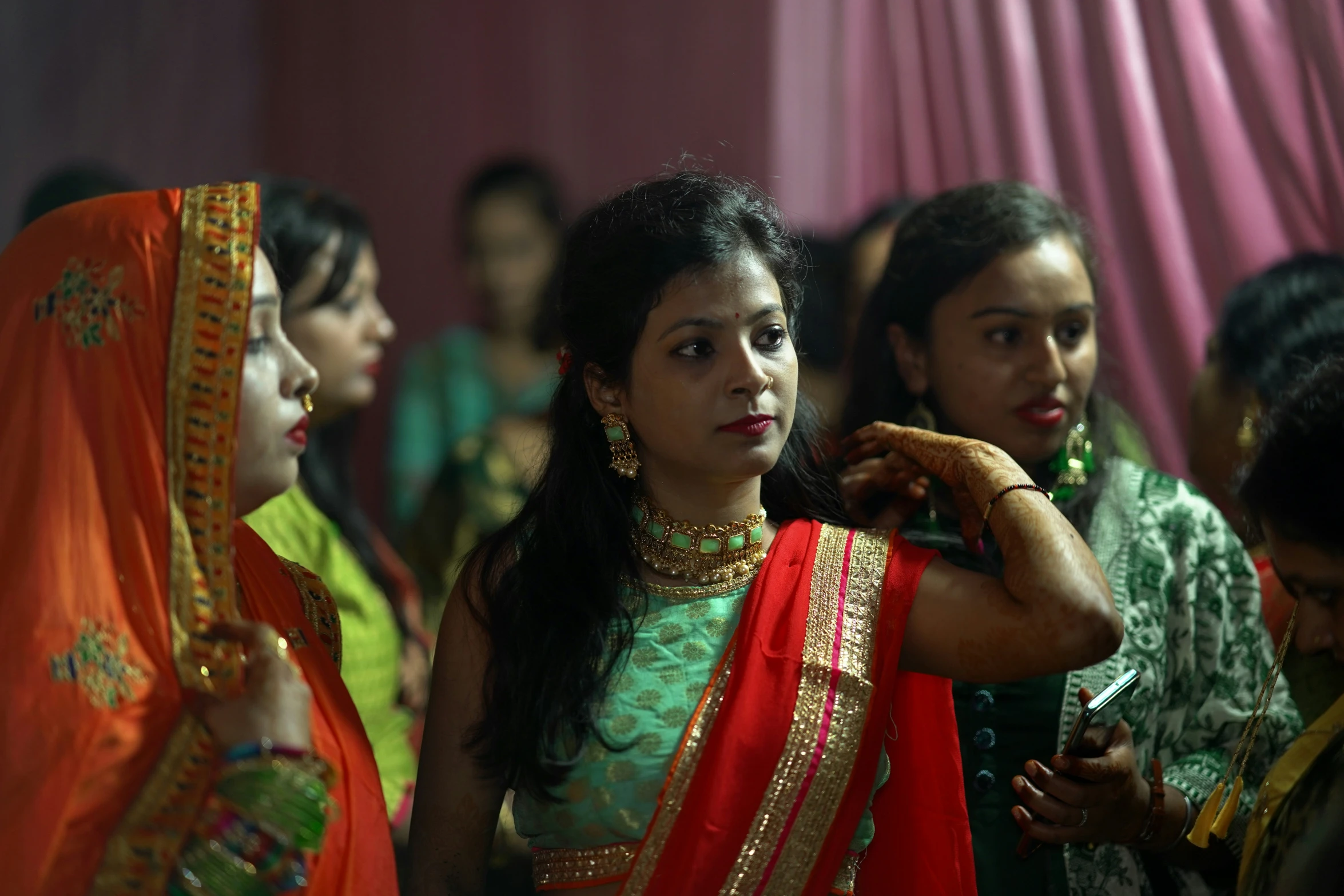 indian women with traditional sari are gathered together