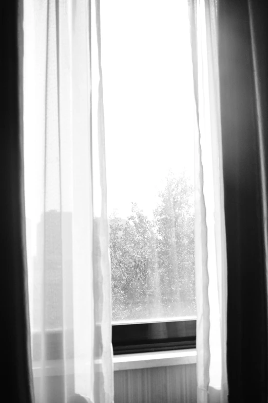 a view of an open window on a rainy day