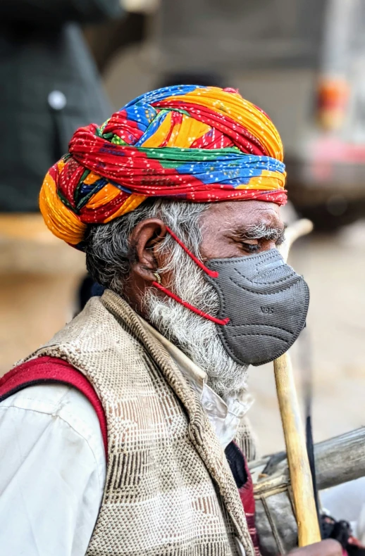 an old man with painted face and a head piece