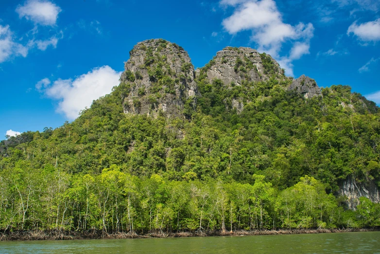 the tall mountains are next to a river