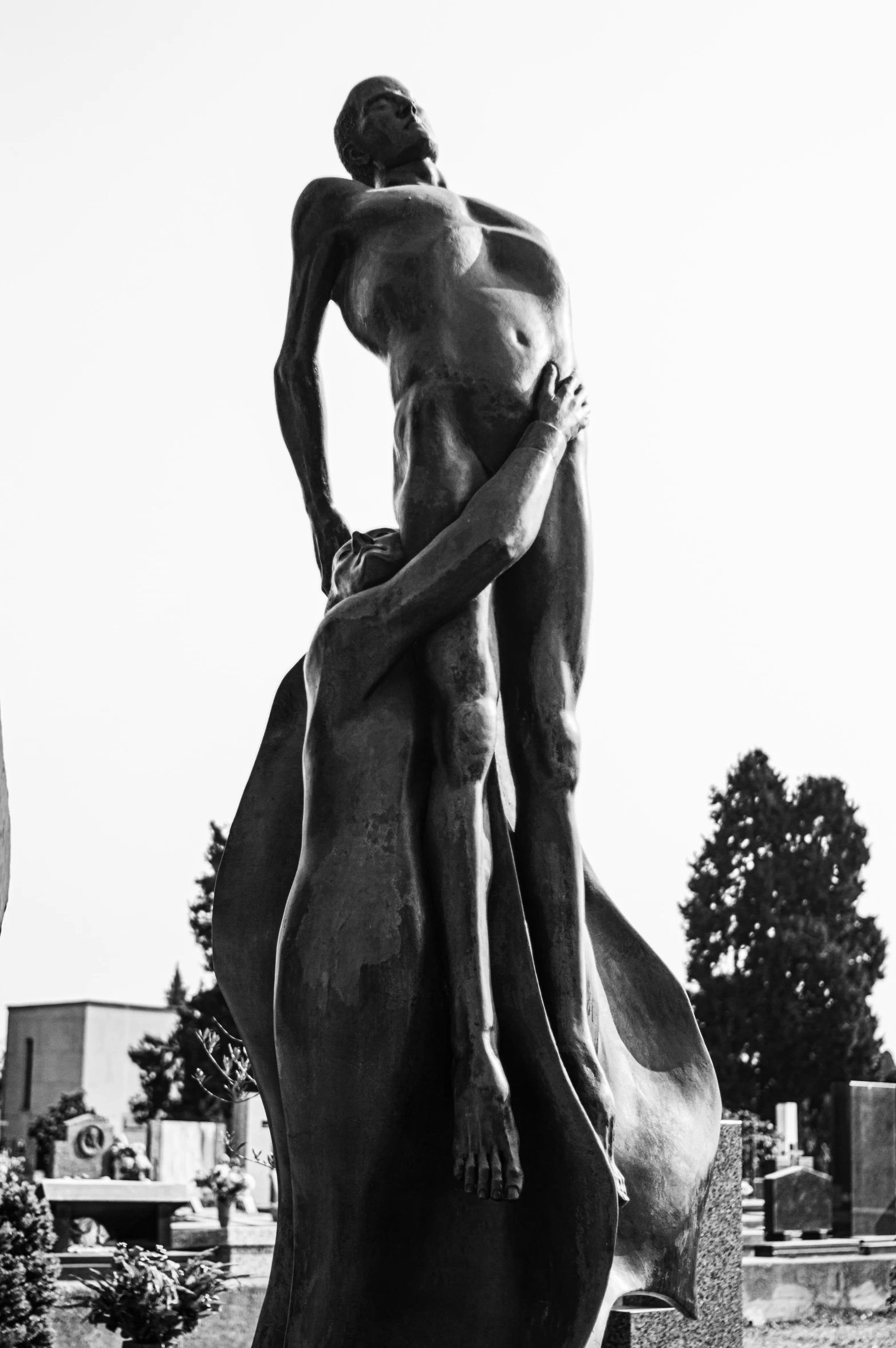 a black and white po of a man standing on top of a horse