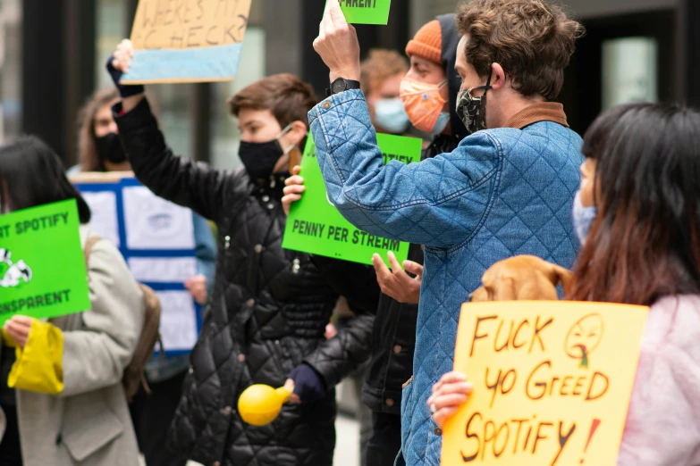 a large crowd of people holding up signs