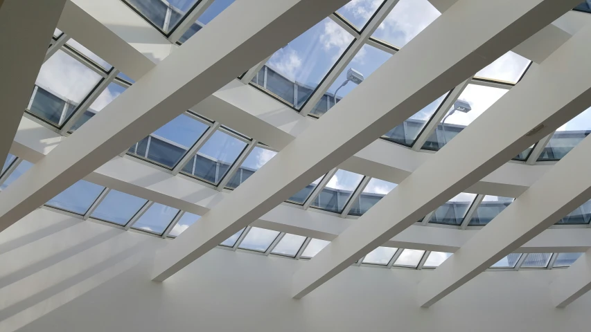 some windows and white buildings are shown against a blue sky