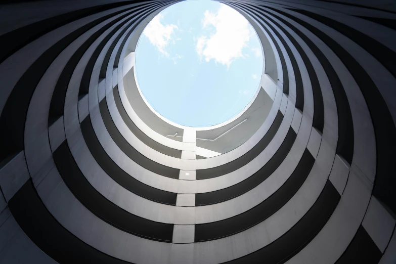 looking up into a round structure with a sky view