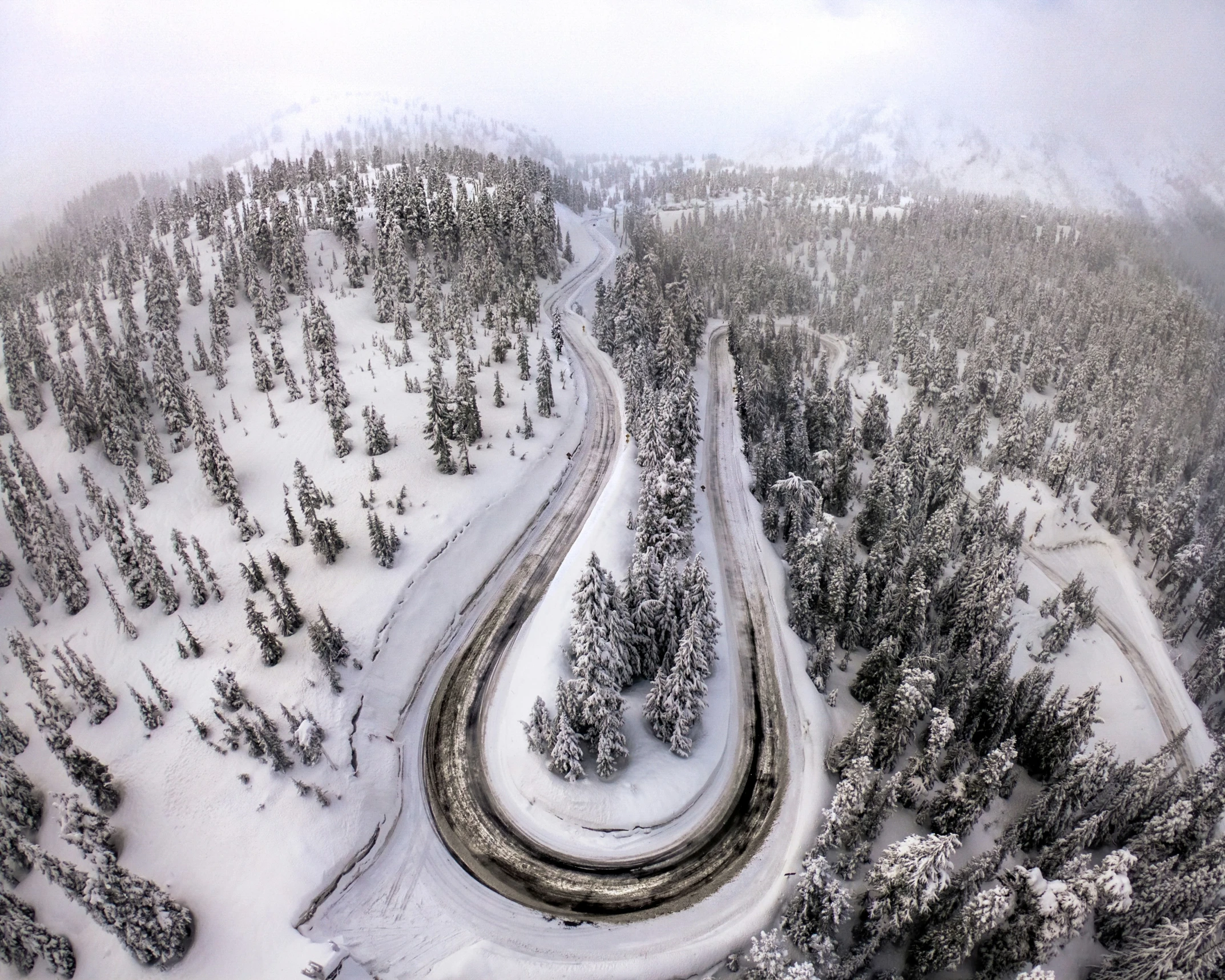 snowy road winding through a snow covered area