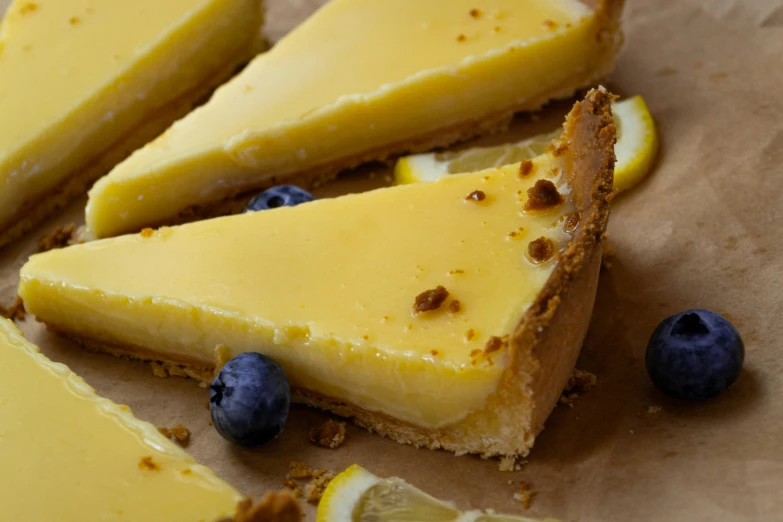 a close - up image of lemon tart with blueberries