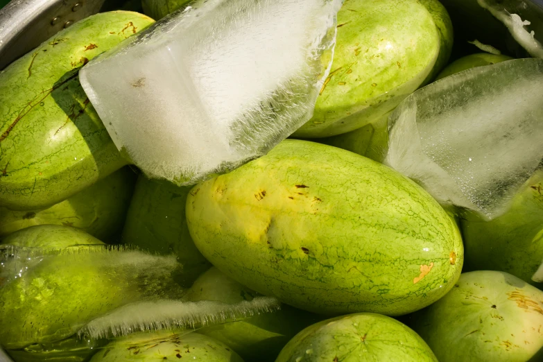 the fruit in the bucket is green and needs to be shaved