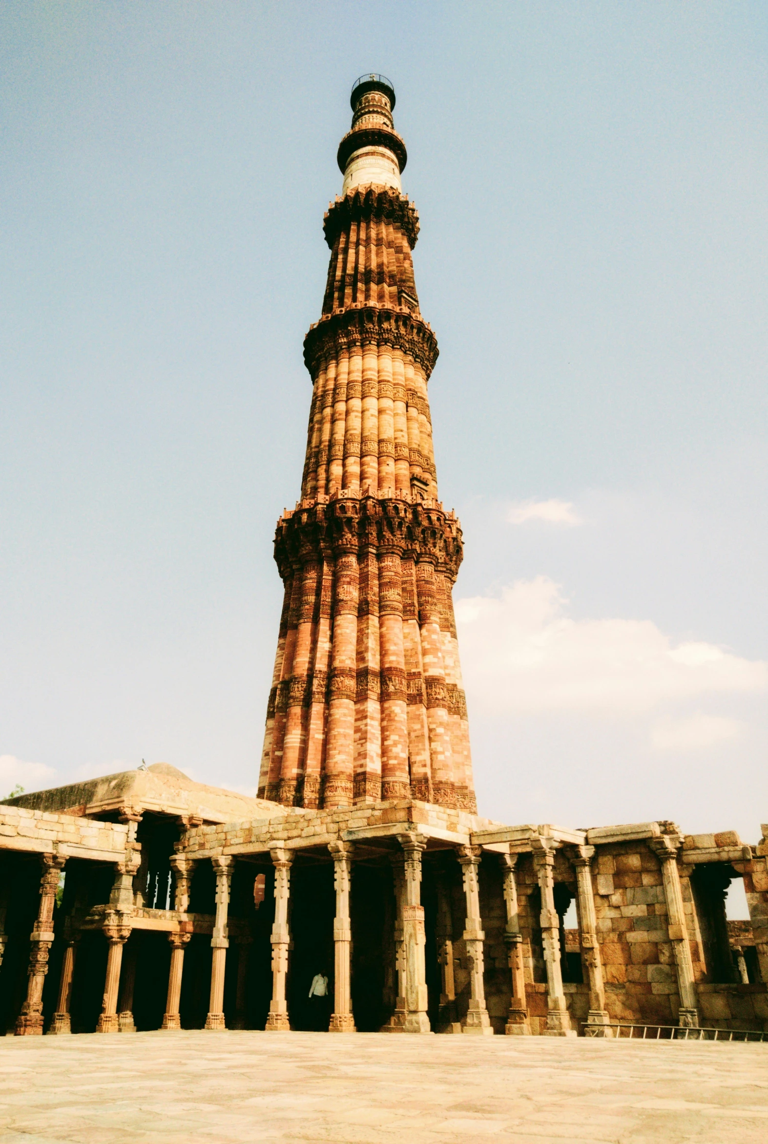 large red stone structure at an outdoor temple with pillars