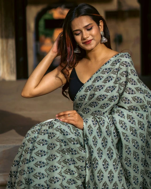 a young lady is in a traditional indian attire