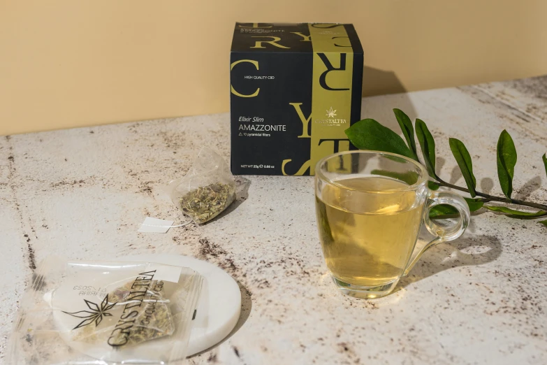 the table holds a glass of tea with a stick of green in front of it