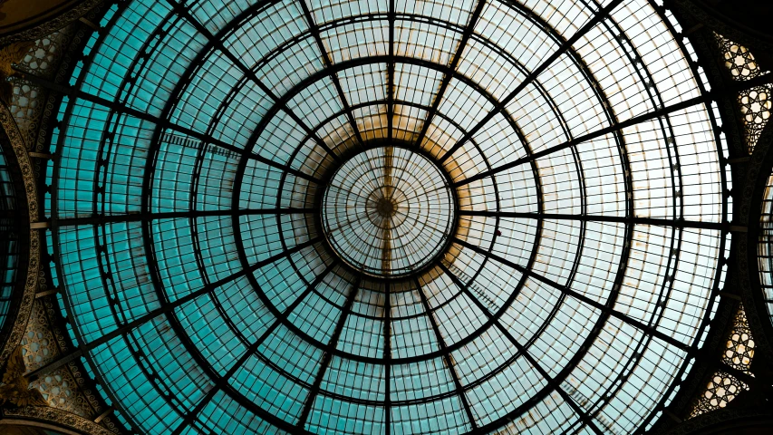 a large glass structure with a clock on top