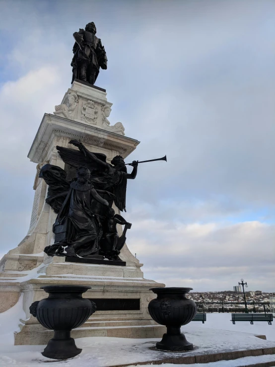 a monument has sculptures in it in the snow