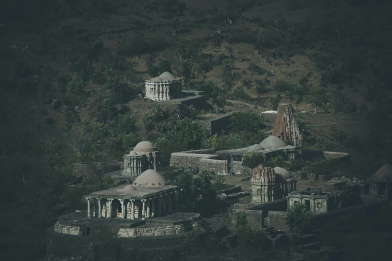 two buildings in the forest are seen from above