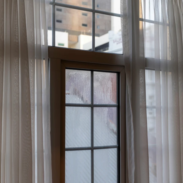 a window with curtains that are open and the window pane is closed