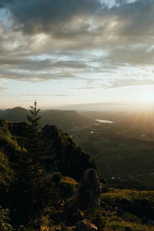 a bench sitting on top of a green mountain