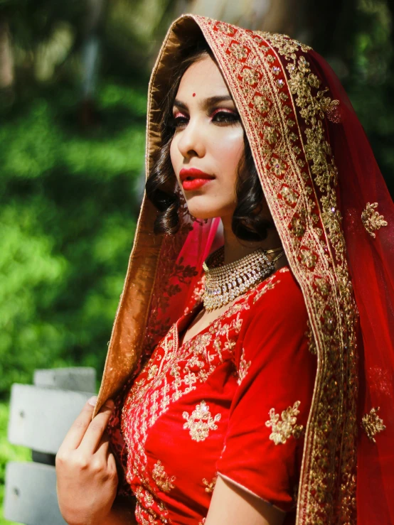 an attractive indian woman in traditional red dress