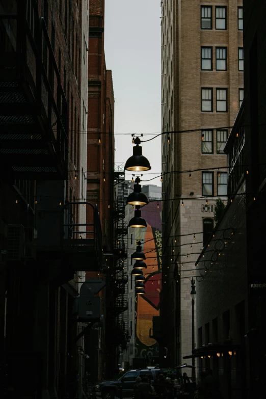 a narrow city street with many buildings and cars