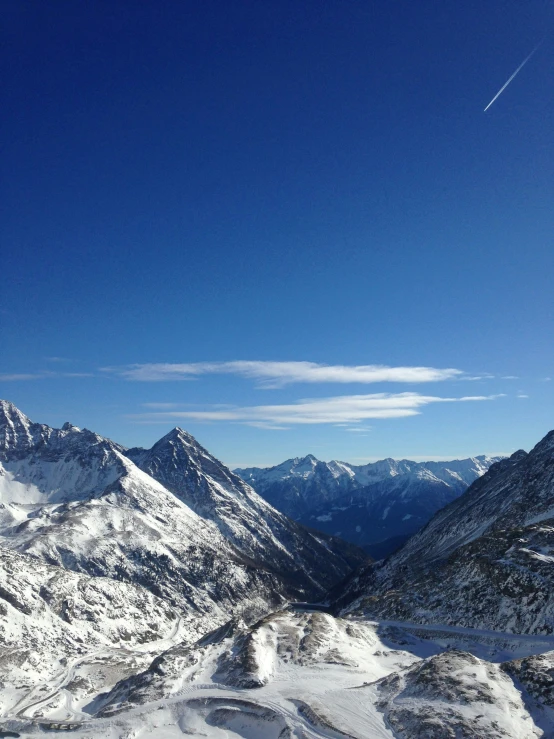 the view from the top of a mountain on a sunny day