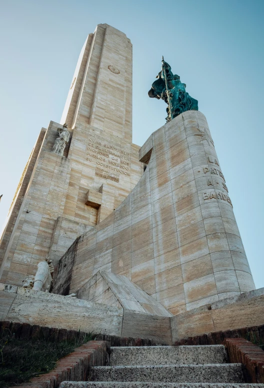 a tall stone structure with a statue on top of it