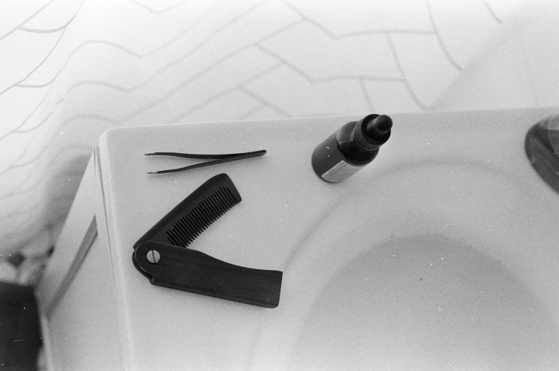 a set of hair brushes are sitting on top of a sink