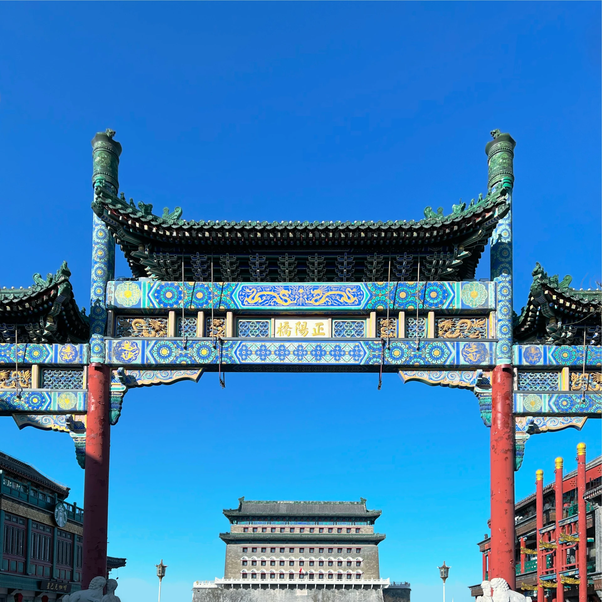 large gates surrounding asian styled building and courtyard