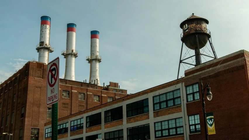 an old brick building has many smokestacks above it