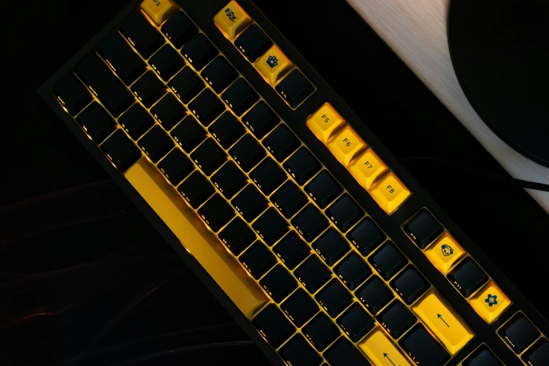 a keyboard with yellow letters on it and a white mouse