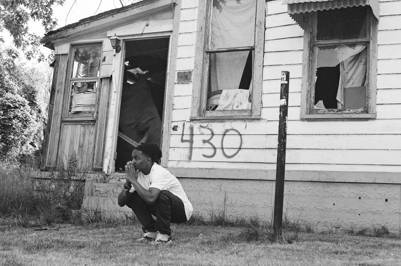 a woman is looking in an old house window