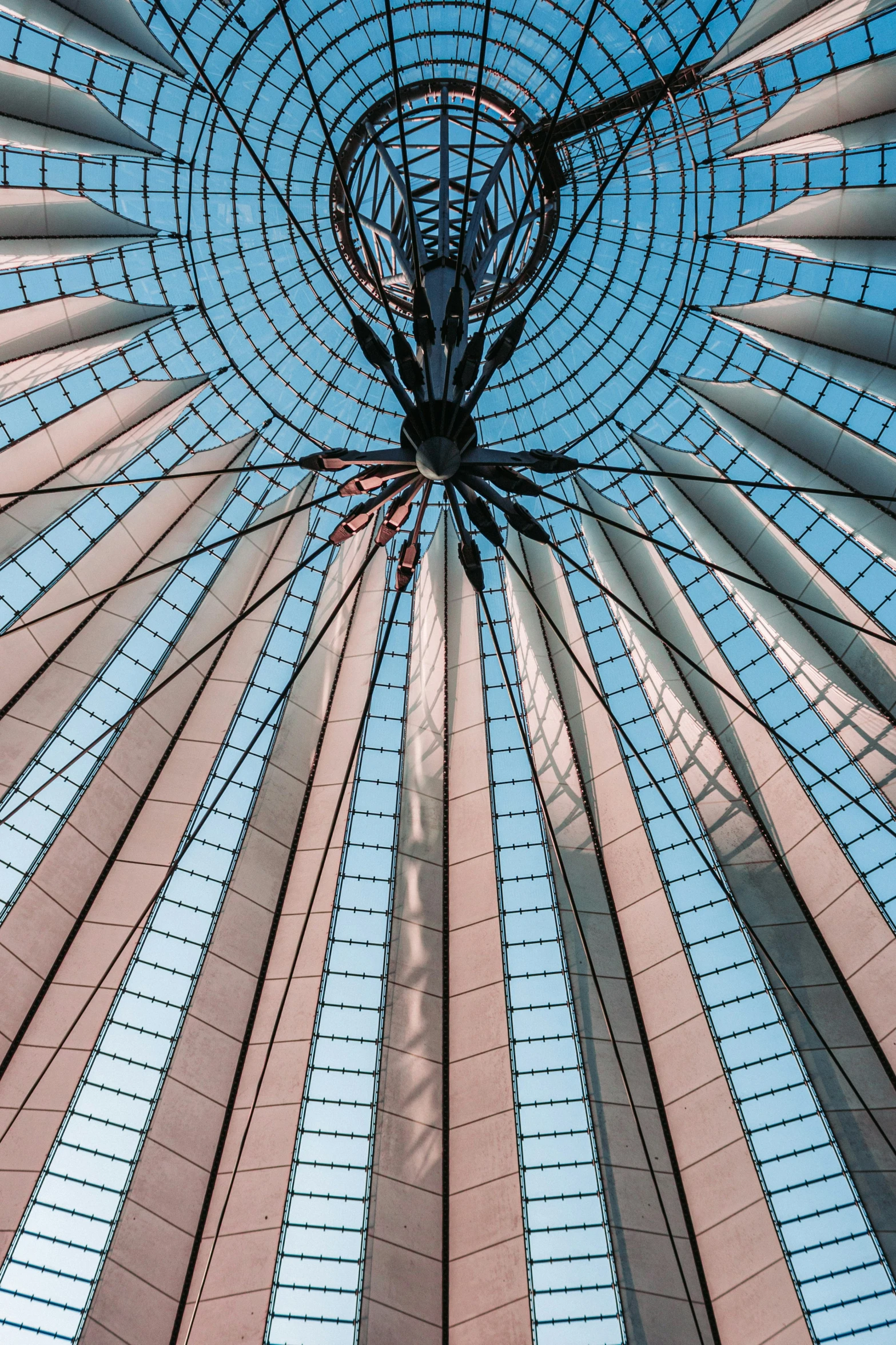 a large glass ceiling with a blue sky