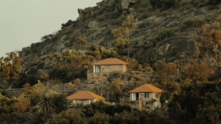 two small cottages are nestled on the top of a hill