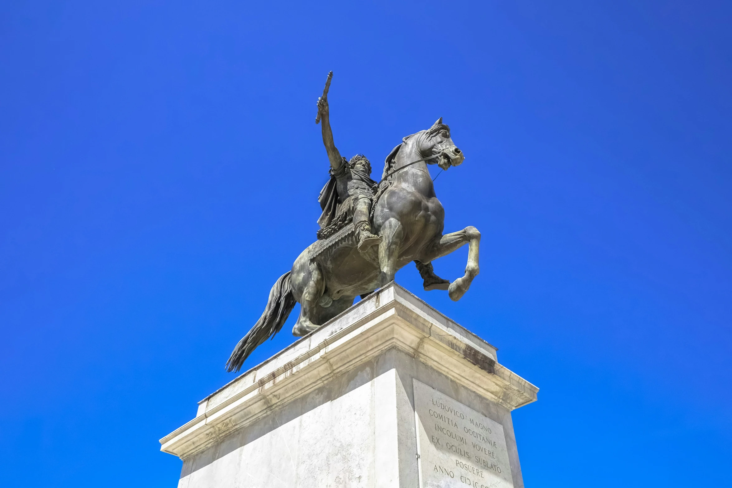 a statue of a person riding on the back of a horse