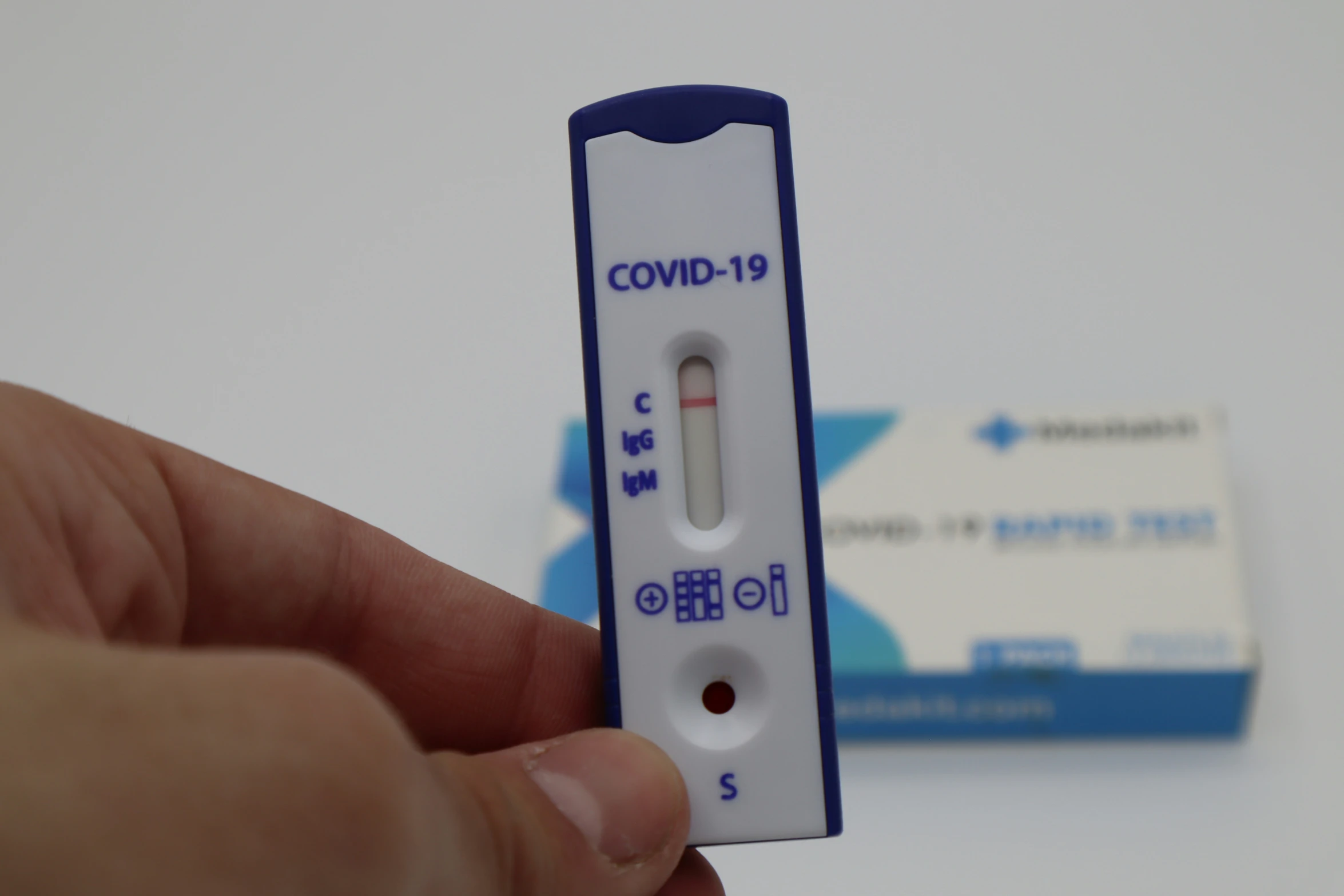 a close up of a person holding a thermometer