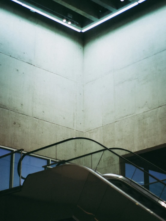 an escalator at an airport that has a skylight above it