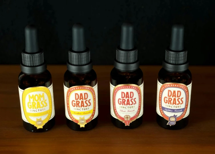 a group of three bottles of father's day beard oils