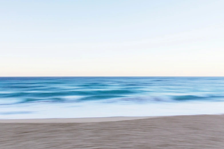 the water on a beach near sand and the ocean