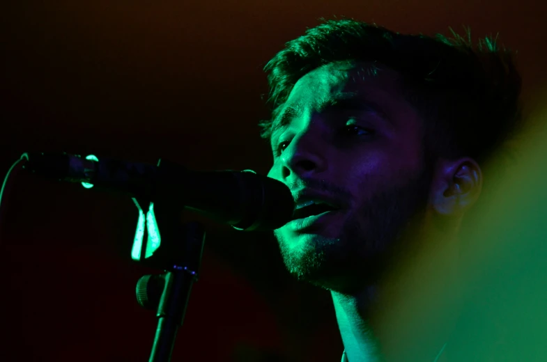 a man that is standing in front of a microphone