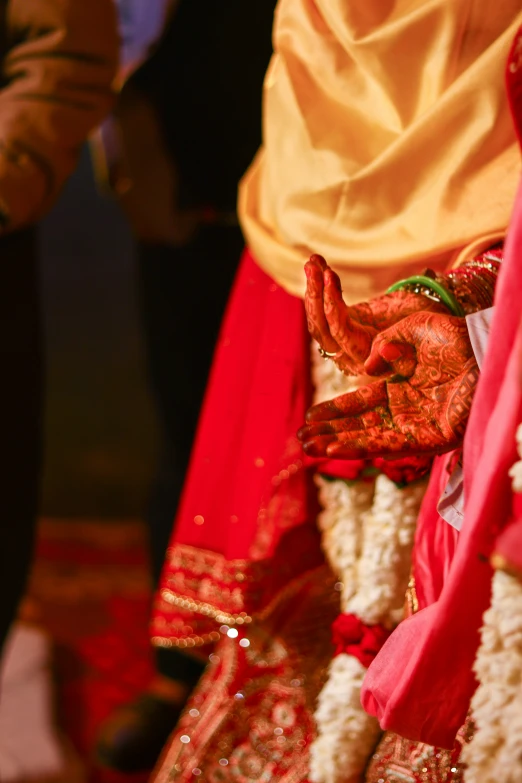 a woman with her hands in her belly covered in bright pink and yellow colors