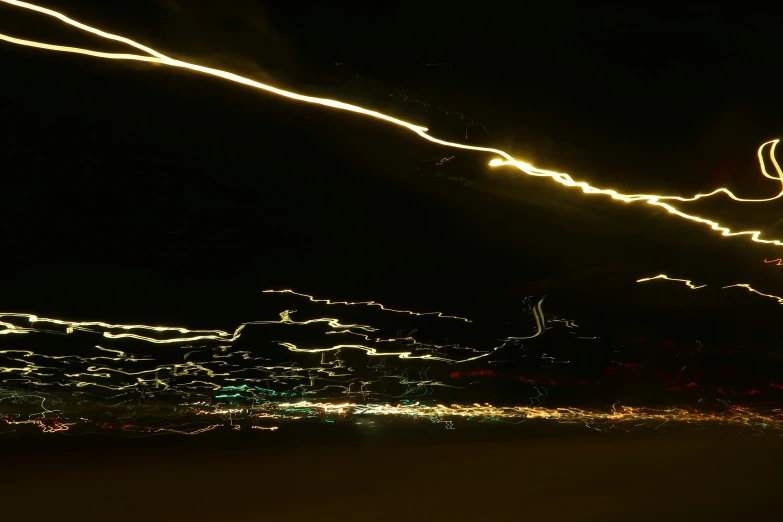 a blurry night with light on the street and buildings