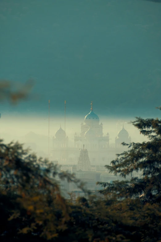 a clock tower sitting on top of a foggy hill