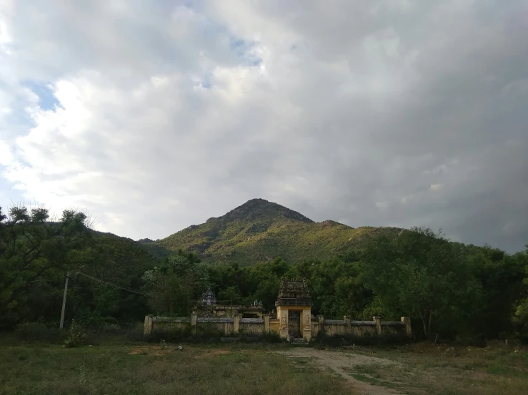 there is a stone structure near the top of a hill