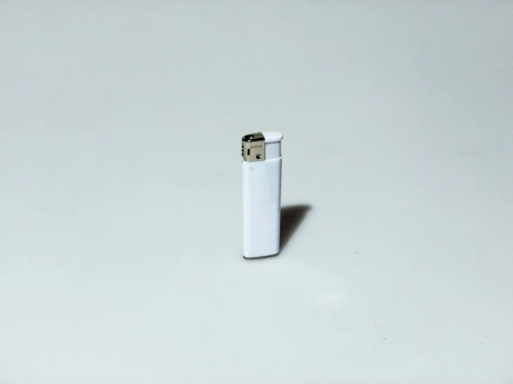 an empty lighter that is on a white table