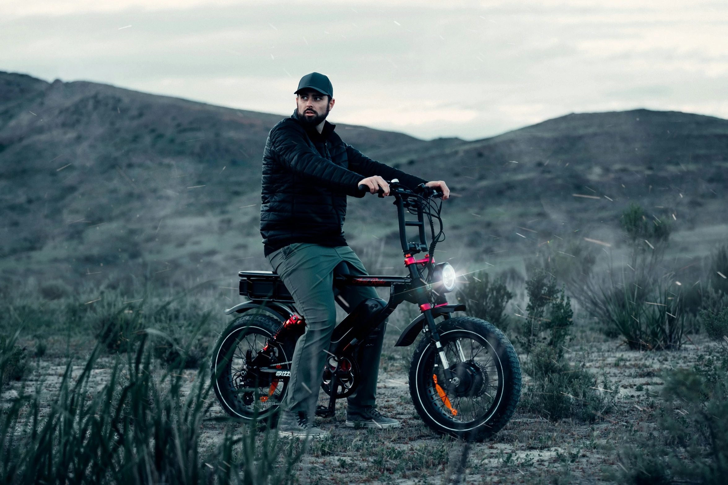 a person on a bike with mountains in the background