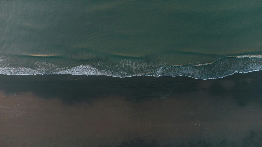 a beautiful green ocean with water and sand