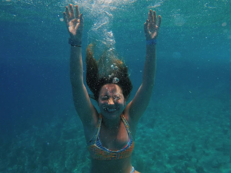 a woman under water with a sun above her head