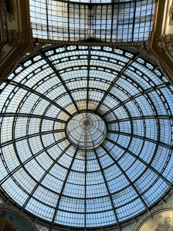 a large, glass roof is in an ornate building