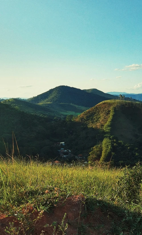 a bench overlooking a hillside with rolling hills