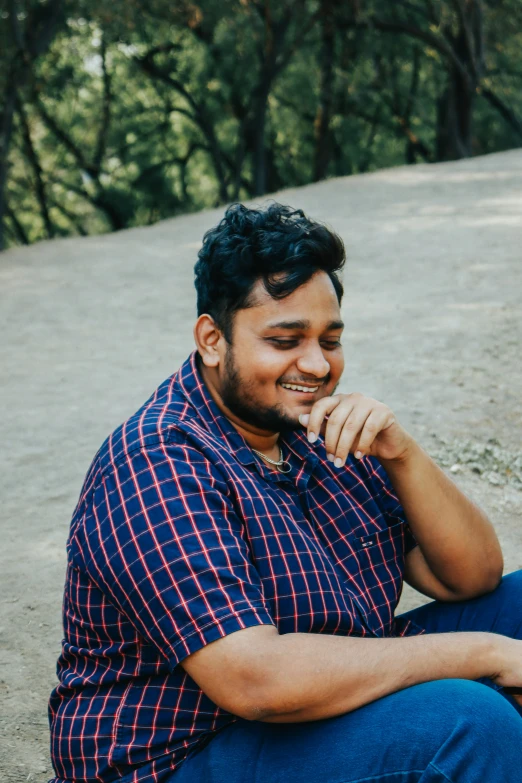 an indian man in the street with trees in the background