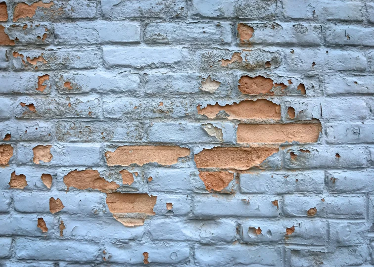 peeling paint on an old brick wall