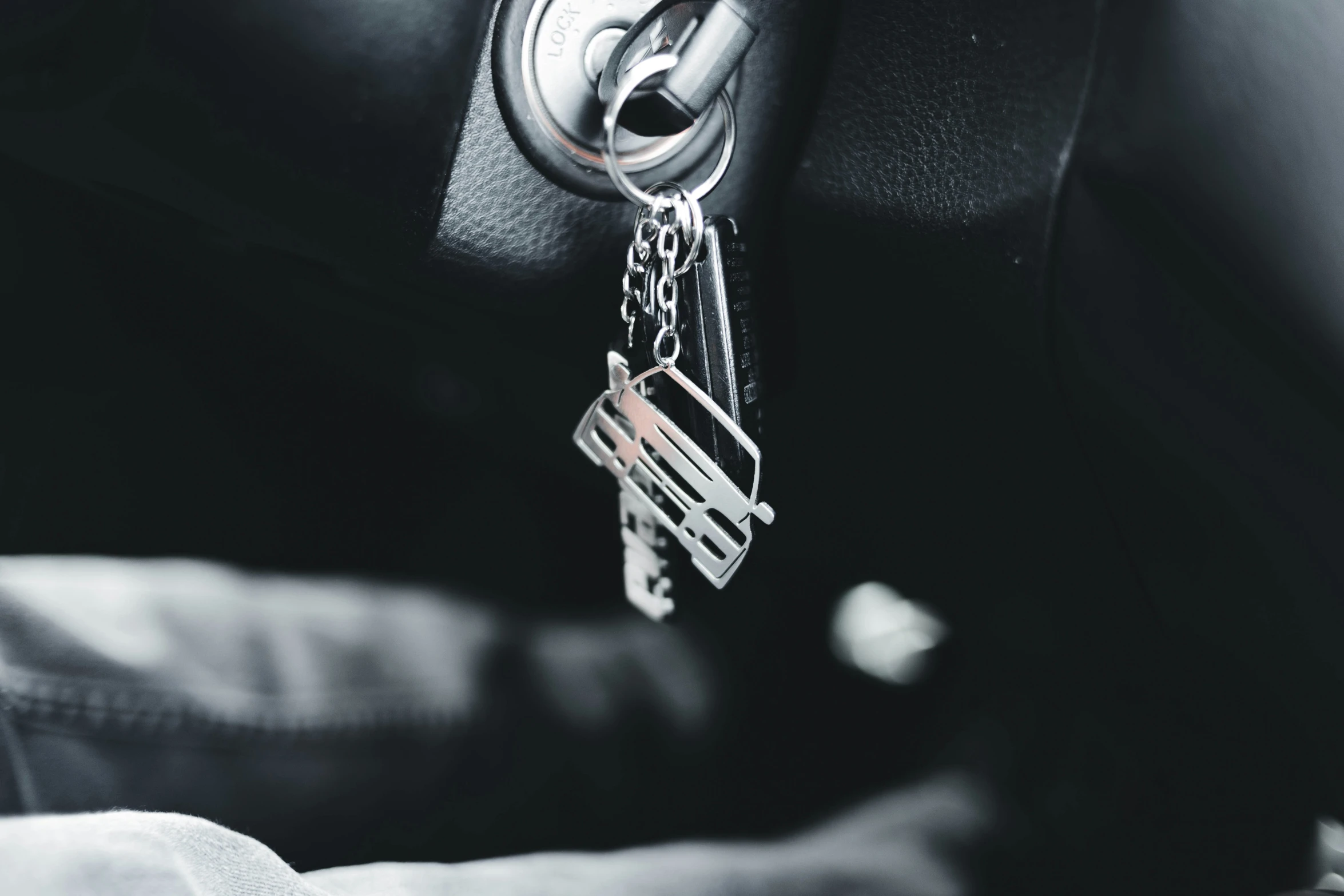 a key chain hangs from the center console of a car