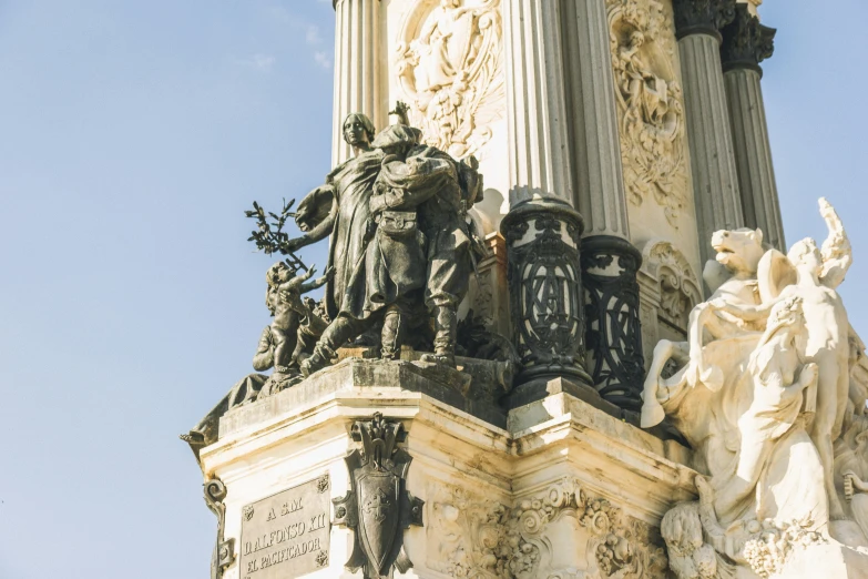 the statue is on top of a tall column